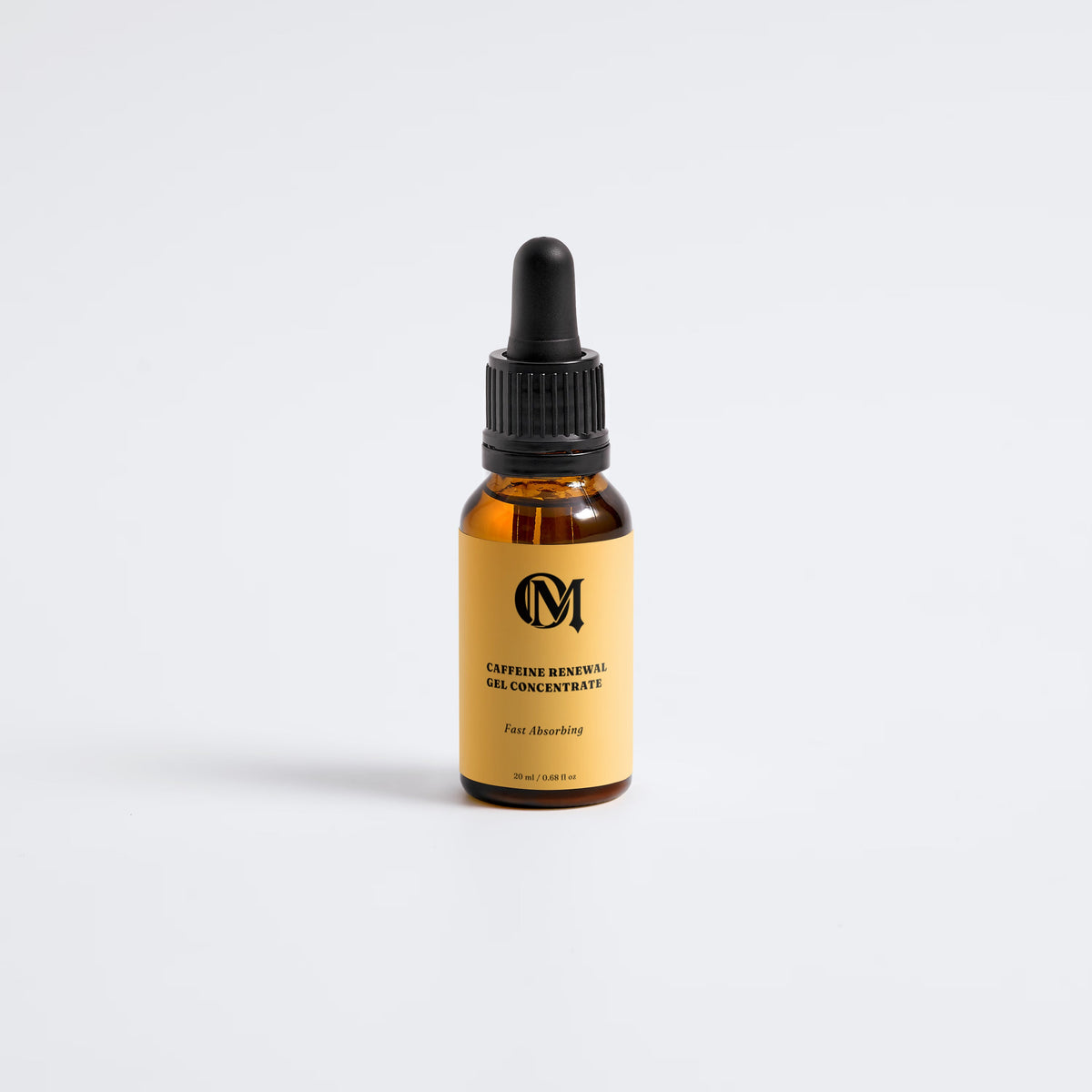 An amber glass dropper bottle of OM Caffeine Eye Serum with a black dropper cap and a tan label, centered on a light gray background.